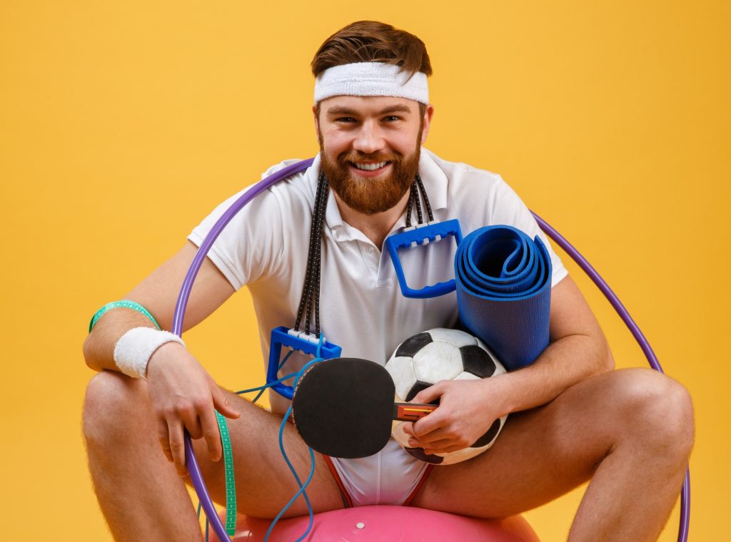 happy cheerful fitness man sitting sports ball